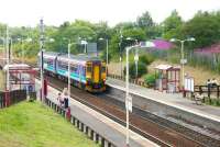 The arrival of this train at Greenfaulds on 26 July 2006 put an end to some of the best cross-platform chat-up lines I have ever heard. The train is a Motherwell - Cumbernauld service and, while the two young men remained on the grass verge, by the time it had restarted its journey, the ladies had boarded a Falkirk Grahamston - Glasgow Queen Street train, which is currently approaching from the right. I wonder if their paths ever crossed again....<br><br>[John Furnevel 26/07/2006]