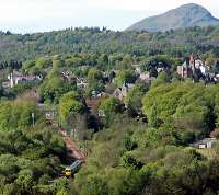 Train leaving Milngavie heading to Glasgow. Dumgoyne and Mugdock bank are seen in the background.<br><br>[Ewan Crawford 15/05/2005]