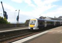 A southbound train standing under the two remaining operational cranes at Burntisland docks in May 2005.<br><br>[John Furnevel 26/05/2005]