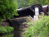 Trains pass at Consall Station and are reflected in the water.<br><br>[Neville Davies //]