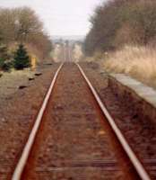 Distant train from Wick approaching Watten level crossing.<br><br>[Ewan Crawford //]