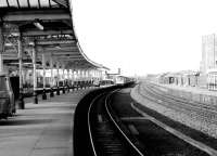 Platform scene at Kilmarnock looking north in October 1982 with a Glasgow Central - Leeds train approaching.<br><br>[John Furnevel 11/10/1982]