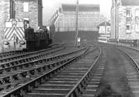 View west towards Leith Central station on the far side of Easter Road in March 1970. The station was in use as a diesel depot at the time (64H) and two of its allocation (D2435 and D2413) stand in the sidings on the left. The tenement block that originally stood here was demolished in 1901 to make way for the bridge across Easter Road into the station.<br><br>[John Furnevel 12/03/1970]