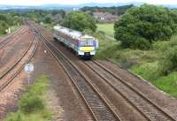 Looking east towards Greenhill Lower Junction in June 2004. A DMU heading for Glasgow Queen Street is about to run through the site of Greenhill (Lower) station (closed April 1966). [See image 6666]<br><br>[John Furnevel 15/06/2004]