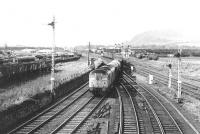 Scene at Niddrie West Junction in 1970 as 5068 passes Niddrie yard with a freight heading for Millerhill. In the centre is the direct freight link through to the ECML at Monktonhall Junction, while on the right is the sub. Beyond the sub are the remains of the trackbed that once climbed to meet the former Lothian Lines route that ran north from Wanton Walls Junction heading for Leith. Niddrie West signal box can be seen in the centre background. Niddrie West junction has seen many further changes over the years since this photograph was taken [see image 50652]<br><br>[John Furnevel 30/04/1970]