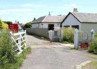 Looking east towards Kincardine village in June 2005 over the level crossing at the southern exit from the yards of the former Kincardine power station.<br><br>[John Furnevel 02/06/2005]