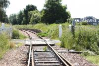 The platform remains at Kincardine station in June 2005. View southeast over the level crossing, with the Kincardine Bridge in the right background. The crossing gave access (right) into the yards of the now demolished Kincardine power station.  <br><br>[John Furnevel 02/06/2005]