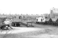 60100 passing Ayr shed in February 1998 with a Killoch - Ayr harbour coal train. On the left are withdrawn class 08 shunters 08718 (nearest) and 08586.<br><br>[John Furnevel 25/02/1998]