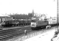 Brush type 4 no 1950 with a diverted Glasgow - Liverpool train, photographed south of Dumfries station in March 1972. The train has just cleared the Annan Road bridge and is about to pass D3172 of Kingmoor MPD shunting the south sidings.<br><br>[John Furnevel 24/03/1972]