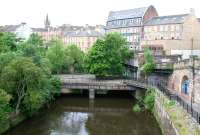 The bridge over the River Kelvin used by the former Glasgow Central Railway, photographed looking south from the roadbridge carrying Great Western Road on 10 July 2005. The platforms of the GCRs Kelvin Bridge station stood on this structure. Eastbound trains arrived via the now bricked up section to the right of the bridge, having run in a tunnel below Great Western Road from Botanic Gardens. [See image 4695]<br><br>[John Furnevel 10/07/2005]