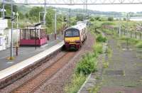 A Glasgow bound train leaving the surviving operational platform at Craigendoran on 27 July 2005. Turning off to the right just beyond the fence is the trackbed of the line that ran onto the pier from which Clyde steamers once operated. (The paddle steamer Waverley was built to operate the Craigendoran - Arrochar route.)<br><br>[John Furnevel 27/07/2005]