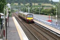 A Glasgow bound train arriving at Anniesland on 10 July 2005 alongside the almost complete bay platform being built to handle trains arriving from Queen Street via the Maryhill curve (which veers to the north-east behind the train).<br><br>[John Furnevel 10/07/2005]