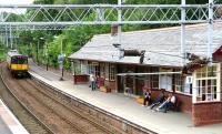 A Neilston - Glasgow Central service arriving at Whitecraigs station in July 2005.<br><br>[John Furnevel 03/07/2005]