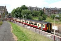 Train for Glasgow Central at Paisley Canal terminus in July 2005. The original station was on the other side of the roadbridge.<br><br>[John Furnevel 29/07/2005]