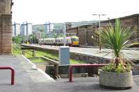 Looking across the bay platform at Greenock Central in the summer of 2005 as a train from Glasgow Central arrives at the station en route to Gourock.<br><br>[John Furnevel 29/07/2005]