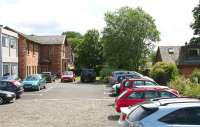 The former Balloch Central station, with the main station building on the left, looking south along the trackbed in July 2005. The A811 runs across the picture behind the trees with the new station standing on the other side of the road.<br><br>[John Furnevel 28/07/2005]