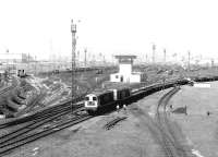 Looking north west at Tinsley Yard in May 1980 showing 20131+20057 passing through with a train of steel flats. Note the catenary on the far left used by electrically hauled trains off the ex-GC Woodhead route, at that time just over two months from closure.<br><br>[John Furnevel 06/05/1980]