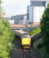 View west on a perfect summer morning on 14 July 2005, with EWS 37427 having run through the abandoned platforms of Easter Road, now accelerating south east towards the ECML and Oxwellmains with the morning <I>Binliner</I> from Powderhall.<br><br>[John Furnevel 14/07/2005]