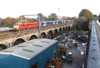 <h4><a href='/locations/S/Slateford_Viaduct'>Slateford Viaduct</a></h4><p><small><a href='/companies/C/Caledonian_Railway'>Caledonian Railway</a></small></p><p>Empty 'Caledonian Sleeper' stock being taken from Waverley for servicing at Polmadie depot hauled by DB liveried 90129 <I>Frachtverbindungen</I>. The colourful combination is seen here westbound crossing Slateford Viaduct on 26 October 2002. Photographed from the towpath of the Union Canal aqueduct. 6/42</p><p>26/10/2002<br><small><a href='/contributors/John_Furnevel'>John Furnevel</a></small></p>