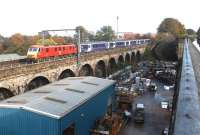 Empty 'Caledonian Sleeper' stock being taken from Waverley for servicing at Polmadie depot hauled by DB liveried 90129 <I>Frachtverbindungen</I>. The colourful combination is seen here westbound crossing Slateford Viaduct on 26 October 2002. Photographed from the towpath of the Union Canal aqueduct.<br><br>[John Furnevel 26/10/2002]