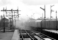 A pair of type 2s southbound into the sun through Stirling with the 10.18 Perth - Motherwell in August 1981. The train carried through vans destined for Manchester.<br><br>[John Furnevel 03/08/1981]