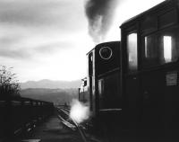 The last train of the day for Blaenau Ffestiniog about to leave Porthmadog station and head out over <I>The Cob</I> on a wet autumn afternoon in 1982.<br><br>[John Furnevel 14/10/1982]