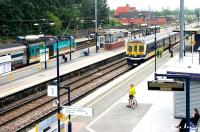 A Bedford - Sutton Thameslink service pulls into West Hampstead (Thameslink) in July 2006, just as a Midland Mainline express passes en route to St Pancras.<br><br>[John Furnevel 21/07/2006]