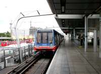 The elevated DLR platforms at Canning Town in July 2005. The North London line, Jubilee line and bus interchange are at ground level. Note passengers waiting at the North London Line platform, bottom left, with the busy bus station beyond. [The NLL route between Stratford and North Woolwich is due to close at the end of 2006 and will be replaced by the DLR's new Stratford International line] [See image 5174].<br><br>[John Furnevel 22/07/2005]