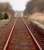 Distant train from Wick approaching Watten level crossing.<br><br>[Ewan Crawford //]
