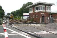 The 13.50 Middlesbrough - Manchester Airport First TransPennine service about to run over Low Gates level crossing on the approach to Northallerton station on 9 July 2012.<br><br>[John Furnevel 09/07/2012]