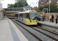 Chorlton-cum-Hardy station closed in 1967 but freight continued to pass through until as late as 1988. After full closure the trackbed was preserved allowing reopening to tram services in July 2011. Metrolink 3016 calls at the new Chorlton tram stop, on the site of the old railway station, on its way to Oldham Mumps.  <br><br>[Mark Bartlett 17/08/2012]