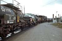 A selection of Hamburg-based tank wagons containing hazardous substances is hauled off the Harwich train ferry on 25th March 1979 by 08460. This was one of the occasions when the ferry was late and the tide was ebbing, resulting in the engine having to pull the wagons up a sharply angled ramp between the dock and the ferry. The shunter crew had been waiting anxiously at the dockside for some time before the ferry hove into view. [See image 50669]<br><br>[Mark Dufton 25/03/1979]