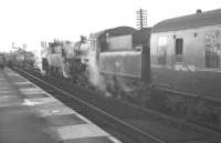 To mark the end of operations over Stainmore summit, the RCTS organised a 9-coach special on 20 January 1962 (weather permitting!). The special is seen at Appleby West  behind 77003+76049. The return trip to Darlington made this the last train to traverse the route. [See image 24103] <br><br>[K A Gray 20/01/1962]