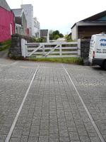 The former branch from Pembroke Dock station to the dock area itself crossing Gordon Street in May 2012, with rails and gates still in position. Little of the old route, closed in 1969, now survives beyond the buildings on the far side of the gates. <br><br>[David Pesterfield 23/05/2012]