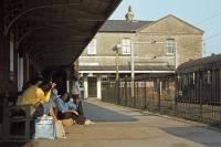 Seaside trippers await their train home at Walton-on-the-Naze station on a warm and sunny 3rd June 1978. Platform 2 is occupied by a stabled Class 302 emu, some way away from its usual haunt on the Fenchurch Street to Shoeburyness line. This platform ceased to be used from May 1982 leaving number 1 for all traffic.<br><br>[Mark Dufton 03/06/1978]