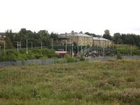 Amongst all that steel is a station. The new footbridge at Normanton Station dominates the station proper in the southerly view across much 'rationalised' former railway land, with the new housing having replaced the former station hotel. [See image 38689]<br><br>[David Pesterfield 26/08/2012]