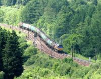 An EWS 66 climbing Beattock Bank approaching Greskine in July 2006 with the Dalston - Grangemouth empty tanks.<br><br>[John Furnevel 13/07/2006]