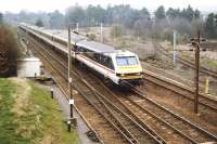 With a fine mist hanging over the Southern Uplands, an unidentified  southbound working in BR InterCity livery completes a high speed descent of the bank and is about to run through Beattock station on a February morning in 1992. <br><br>[John Furnevel 17/02/1992]