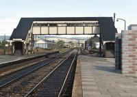 Although the up platform buildings at Craven Arms had been replaced by a shelter (a very sturdy looking one it has to be said), this September 1972 view north under the covered footbridge reveals that the carriage shed (left) and goods shed (right) were still extant, albeit no longer part of the active railway. <br><br>[Bill Jamieson 11/09/1972]