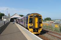 158702 waits to form the last departure of the day from Thurso, the 1629 to Inverness. Compared to a similar view five years earlier [See image 16892], the goods shed has now been demolished but not yet replaced although the passenger trainshed still forms an impressive backdrop.<br><br>[Mark Bartlett 06/07/2012]