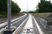 The tram route near what will be Edinburgh Park Central, between Edinburgh Park station and Gyle Centre. View south on 30 August 2012 towards the flyover west of Edinburgh Park station [see image 34390], with the Pentland Hills on the horizon. One 'side benefit' of the delay to the trams project has been the additional time for the establishment of the trees now screening the numerous office blocks located here along both sides of the route. <br><br>[John Furnevel 30/08/2012]