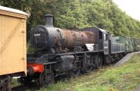 <I>The Carmyllie Pilot</I>, aka Ivatt 2-6-0 no 46464, awaiting restoration at Bridge of Dun in August 1992. The sign reads 'Brechin Caledonian Railway, donations gratefully received'. [See image 19076]<br><br>[John McIntyre 09/08/1992]