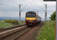 Looking west from Geilston level crossing near Cardross as 320321 approaches during the early evening of 29 May 2010 on a Helensburgh to Airdrie service.<br><br>[John McIntyre 29/05/2010]