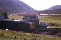 A Class 40 struggles up the hill past Dalnaspidal box in 1977. When local stations between Perth and Inverness were closed in 1965, it was a condition of closure that the Dalnaspidal platforms were retained in case of emergency needs when the A9 was blocked by snow. It is not known if the station was ever subsequently used in emergency, or whether the condition is still in force - but the platforms are still there! [See image 26748]<br><br>[Frank Spaven Collection (Courtesy David Spaven) //1977]