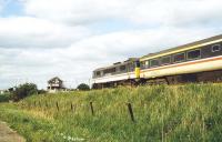 A class 86 on the back of a diverted Liverpool Street - Norwich service being dragged through Shippea Hill by a class 47 in June 1997 (due to a fallen tree blocking the main line at Diss). The working is doubly unusual in that the train is also running wrong-line following a points failure.<br><br>[Ian Dinmore /06/1997]