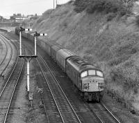 5M48 was that well known working, the Heaton to Manchester Red Bank newspaper empties, although in diesel days the motive power was a bit more mundane than the variety of double-headed steam which had taken it through the Pennines in earlier years. On 19 July 1975 'Peak' No. 45058 slows on the approach to Goose Hill Junction, Normanton, where it will cross over from the up fast onto the Calder Valley line.<br><br>[Bill Jamieson 19/07/1975]