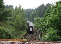 The tail lamp on the rearmost <I>Caledonian Sleeper</I> coach glows brightly as the train runs through the platforms of long closed Culloden station on the last leg of the overnight journey from London Euston. <br><br>[Mark Bartlett 04/07/2012]