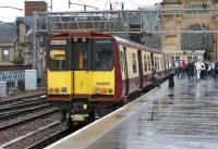 314209 has just arrived at Glasgow Central's short platform 11a on 15 October 2008 with a Cathcart Circle train. Two years later this platform ceased to exist when the newly created platforms 12 and 13 were commissioned on the site of the former station car parking area, with rail access via the arch in the background [see image 29298].<br><br>[John McIntyre 15/10/2008]