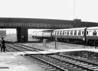 <I>'Good grief... there's a story here about the possibility of tilting trains in the future!'</I> A couple of sceptics catch up with the latest news on the barrow crossing at Rotherham Masborough on a sunny afternoon in May 1981. Meantime, a York - Bristol express runs south through the station at speed behind 47445.<br><br>[John Furnevel 04/05/1981]