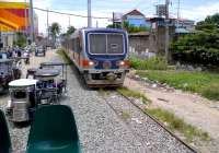 A 2009-built Hyundai Rotem DMU arrives at Alabang, which is the outer limit of commuter services from the Tutuban terminus. There is a wealth of detail in this picture - notice the informal platform seating, the motorcycle and sidecar taxis, the vividly painted building on the left; and last but not least, the array of domestic electricity meters conveniently grouped together for reading purposes, atop the wooden pole on the right. The mesh cover on the windscreen is interesting: knowing the locals as I do, I consider it more likely to protect against accidents than against vandalism.<br><br>[Ken Strachan 01/09/2012]